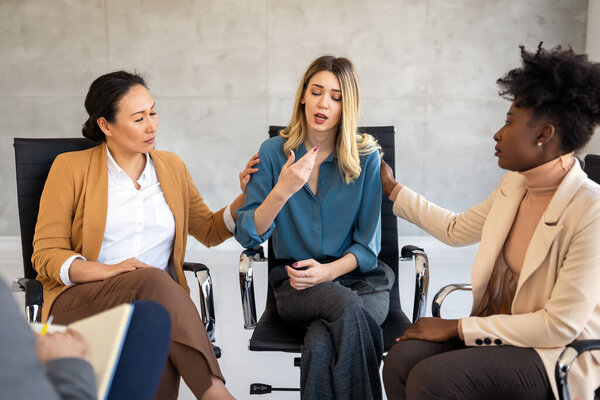 Business team having a meeting in the office and solving a problem. Teamwork, people and crisis concept. Depressed by failure, bad news, feeling desperate about company bankruptcy or financial crisis.