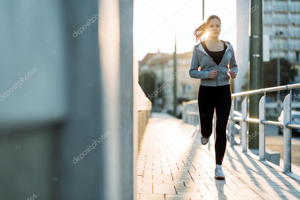 Sporty woman jogging in city