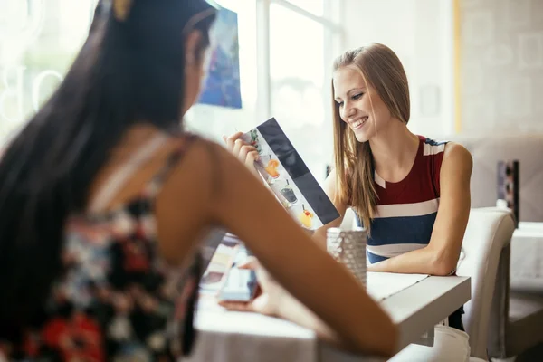 Women looking at the menu in restaurant — Stock Photo, Image