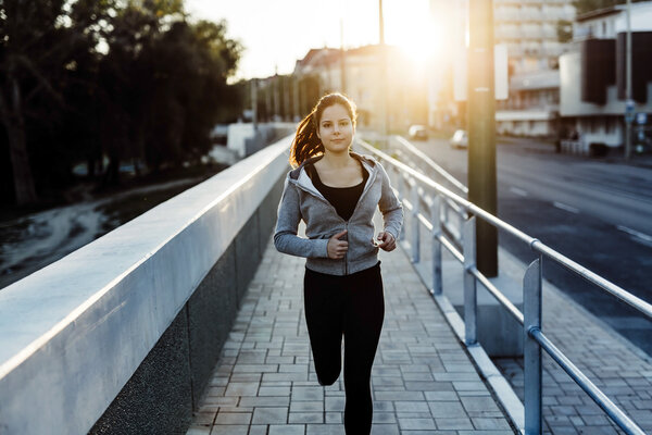 Beautiful female jogging in city