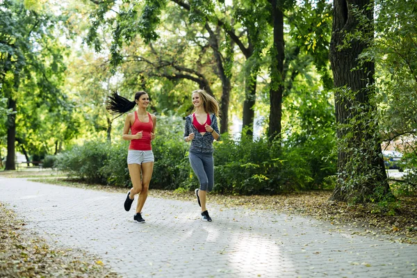 Young fit women jogging outdoors — Stock Photo, Image