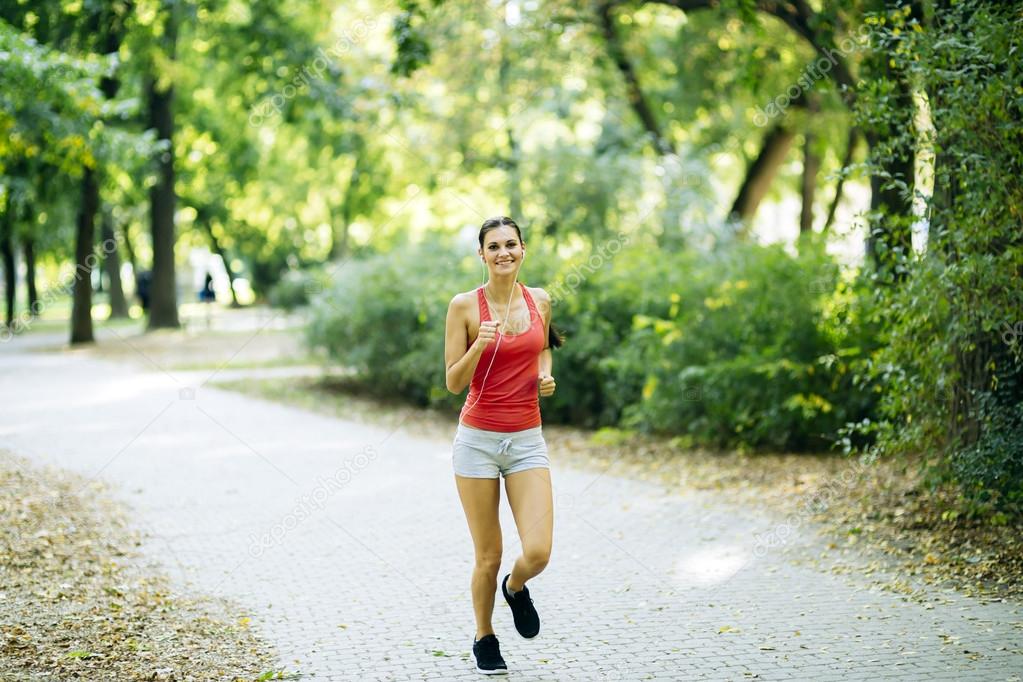 Young beautiful athlete jogging in park