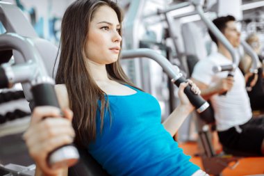 Spor salonunda egzersiz yapan insanlar