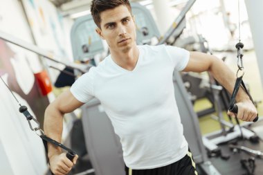 Yakışıklı adam temiz modern spor salonunda eğitim