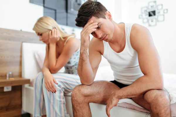 Worried couple having problems in bedroom — Stock Photo, Image