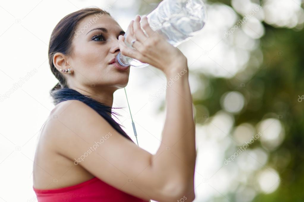 Attractive woman drinking water