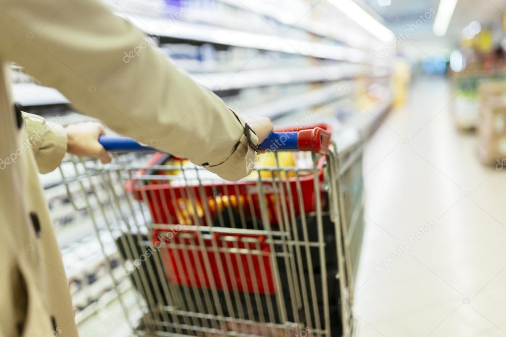 Woman pushing shopping trolley