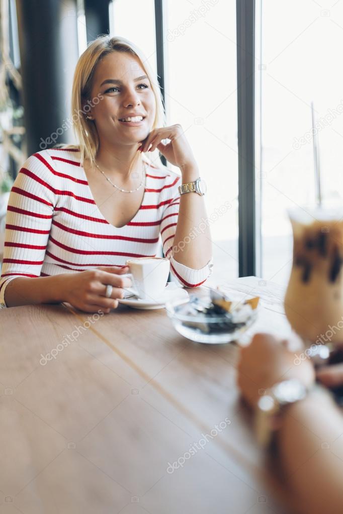 Women drinking coffee and gossiping