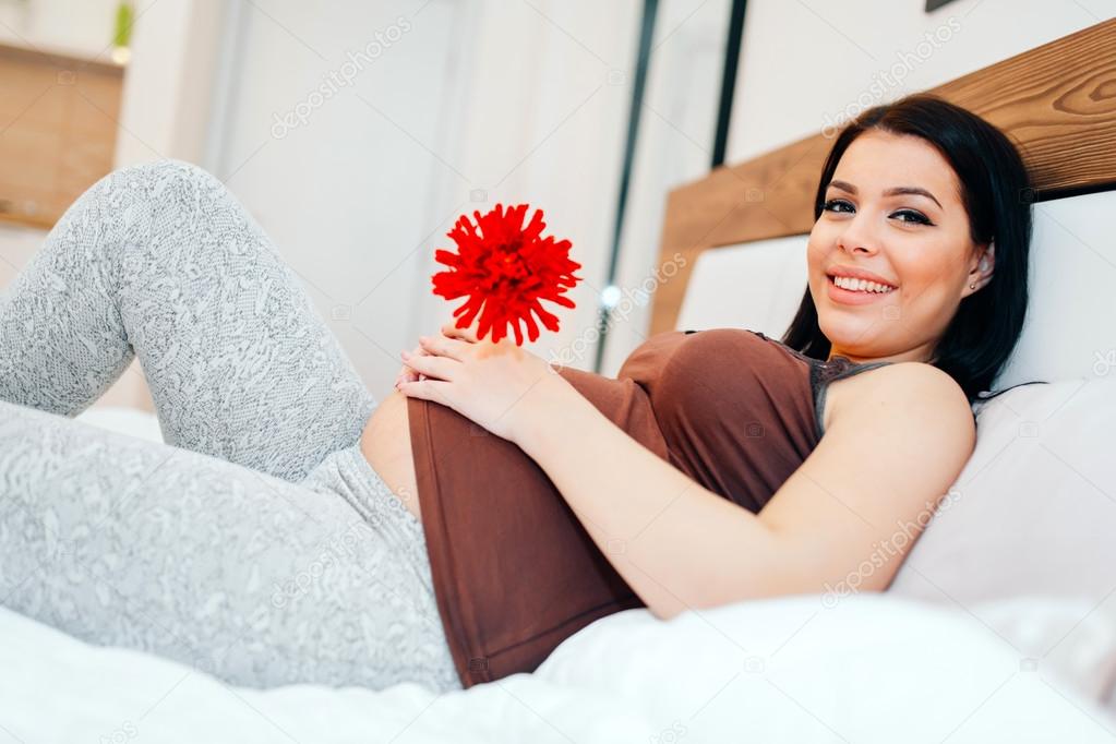 Pregnant woman happy for flower