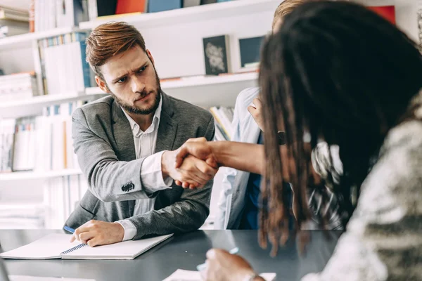 Business people shaking hands with a client — Stock Photo, Image