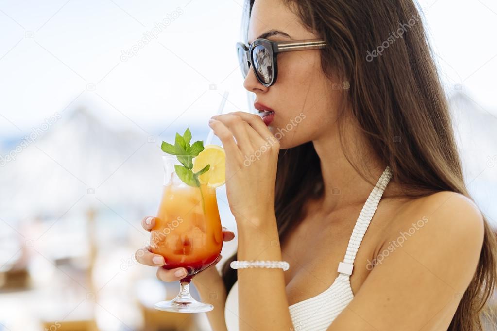 Attractive woman drinking cocktail