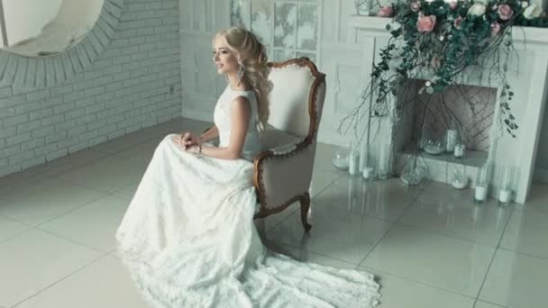 La ragazza in abito da sposa sorridente e guardando da un lato all'altro — Video Stock