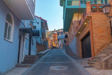 Tiflis, Gürcistan - 03 Nisan 2021: Eski Tiflis kasabasında ahşap oymalı balkonlu renkli geleneksel evler.