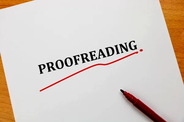 Proofreading word on white sheet with red pen — Stock Photo, Image