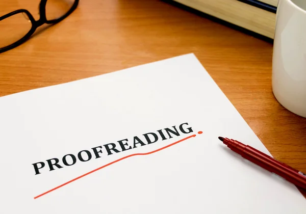 Proofreading word on white sheet with red pen — Stock Photo, Image