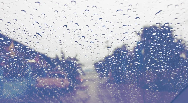 Raindrops on windshield on road — Stock Photo, Image