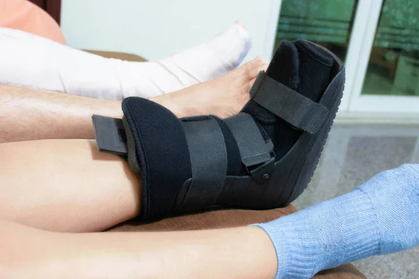 boot support on womon's leg to support her injured ankle from accident