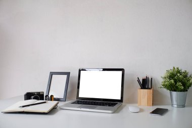Çalışma masası ve dizüstü bilgisayar. Boşluğu ve boş ekranı kopyala. İş görüntüsü, boş ekran dizüstü bilgisayar ve malzemeler.