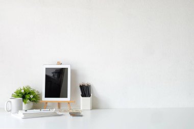 Mockup çalışma masasının kırpılmış görüntüsü ve uzay kitapları, bitki ve kahveyi beyaz masaya kopyalamak. 