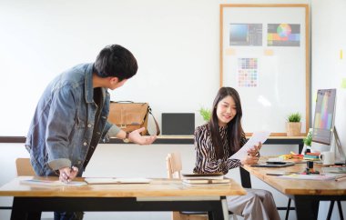 Team of professional designers working with new startup project in modern office.	