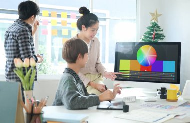 Group of young designer at meeting table for discussing the new successful startup project.	