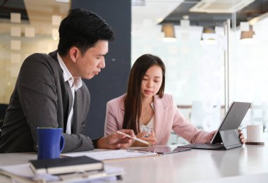 Business people in the office are planning a strategy for the future of the business.	