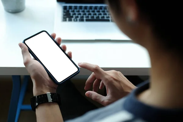 Close up view of businesswoman holding mobile phone with blank screen.	