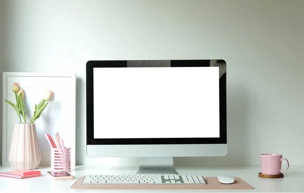 Modern workspace with computer with blank screen and equipment on white table.Blank screen for your information.