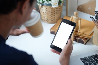 Metin mesajınız veya bilgi içeriğiniz için boş ekranlı akıllı telefonu tutan erkek eli görüntüsü, şehir ortamında cep telefonundan mesaj okuyan kadın görüntüsü.