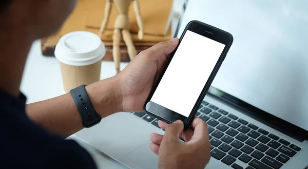 Mock up smartphone of hand holding black mobile phone with blank white screen.