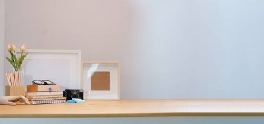 Modern workspace desk and copy space book, plant and coffee cup on wood desk.	