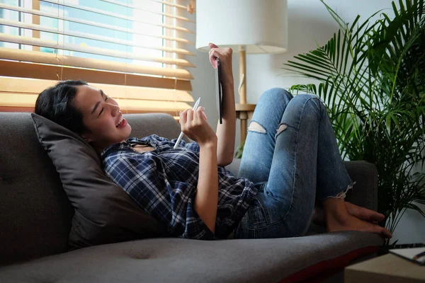 Smiling Young Woman Sitting Comfortable Sofa Using Digital Tablet — стокове фото