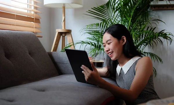 Smiling Young Woman Sitting Comfortable Sofa Using Digital Tablet — стокове фото
