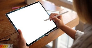 Yaratıcı ofiste dijital tabletle çalışan tasarımcı kadın.