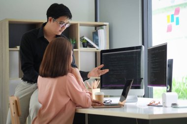 Side view of female programmer working with computer at modern office. Developing programming.	