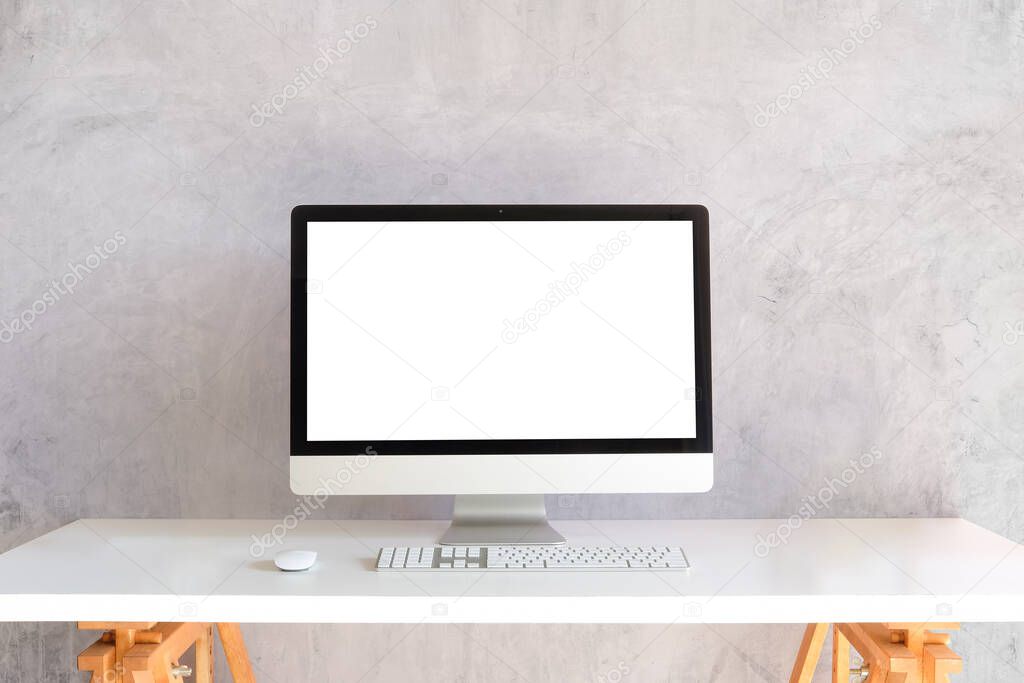 Mock up computer with empty screen on white table with cement wall.