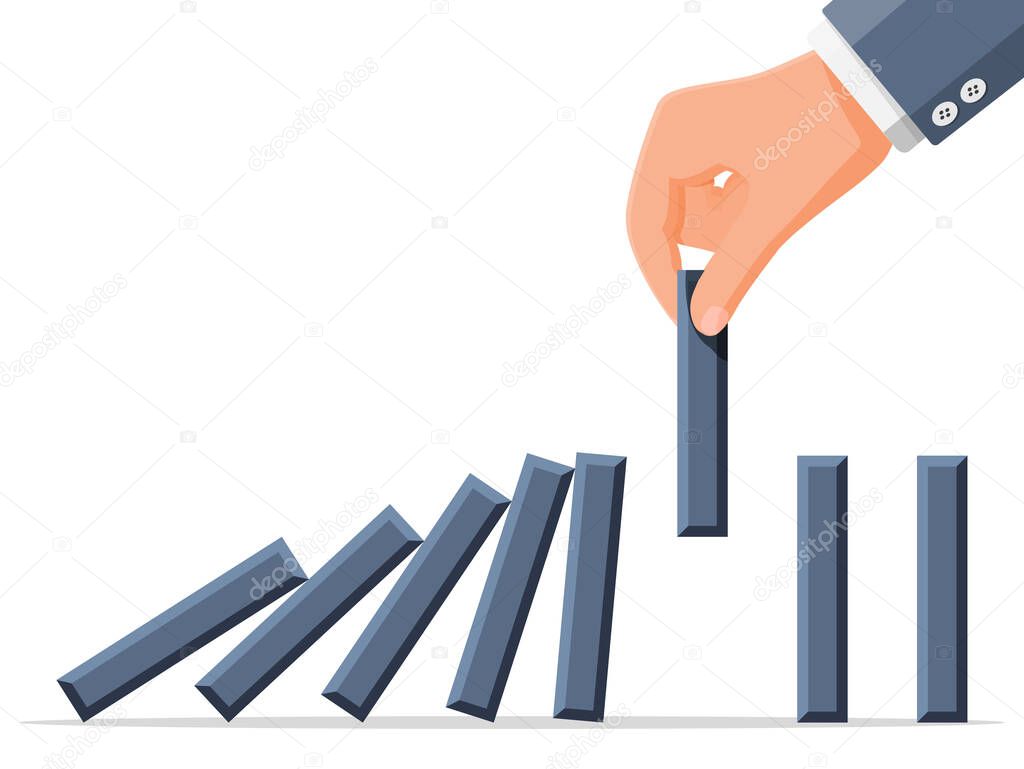 Businessman hand stopping domino effect.