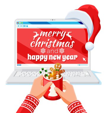 Laptop Noel Baba şapkası ve kahve kupasında.