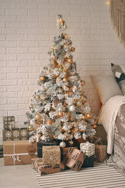 A new year interior in boho style, tree with gifts.