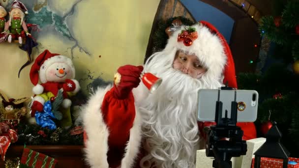 Cheerful Santa Claus congratulates remotely with video calling on Christmas and New Year holidays in virtual online chat during self-isolation in quarantine. Close-up. — Stock Video