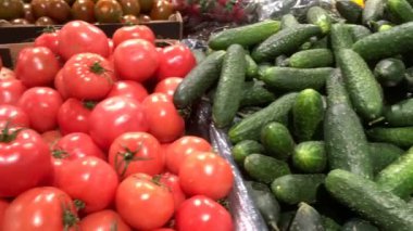 Çiftçi pazarında ya da süpermarketin sebze bölümünde satılık bir sürü olgun meyve, domates ve salatalık var. Vejetaryen yemeği. Yakın plan..