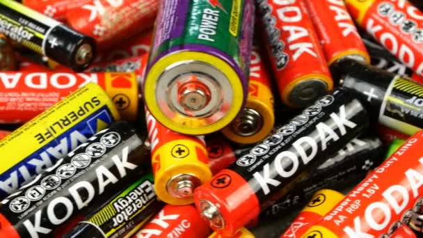 Kiev, Ukraine, May 2021: - Many used single-use alkaline multi-colored batteries from different manufacturers for recycling to avoid pollution environment of planet Earth. Dolly shot. — Stock Video