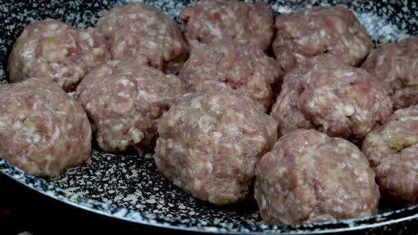 Memasak bakso lezat dalam saus tomat krem di penggorengan. Potongan bulat kecil yang diisi dengan saus pedas direbus dalam wajan. Dapur domestik. Close-up. — Stok Video