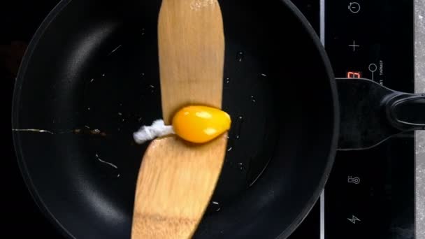 Unsuccessful turning egg yolk on hot pan and cooking fried eggs. Eggs cooking. Simple tasty homemade food preparation concept. Inept cook. Close-up. — Stock Video