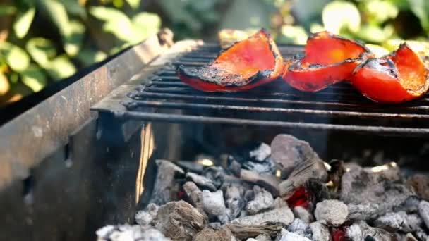 Appetising vegetables red bell peppers prepared on grill or open barbecue, are flip them with cooking tong during frying. Hot tasty vegetarian or vegan healthy food. Close-up. — Stock Video