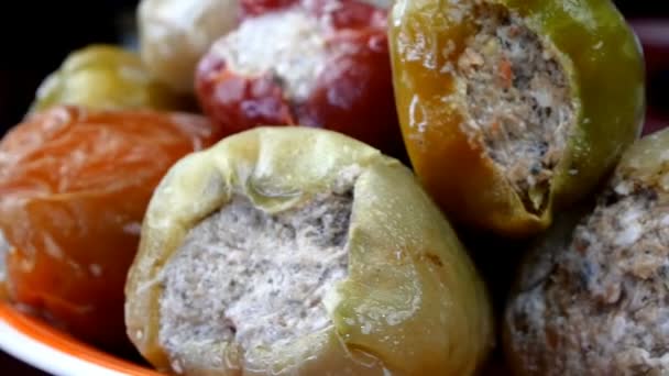 Frozen semi-finished products, stuffed bell peppers rotate on counter in market or on table in the home kitchen. Selective focus. Soft focus. Slow motion. Close-up. — Stock Video