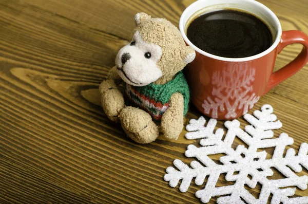 Cup of coffee, snowflake and toy monkey. — Stock Photo, Image