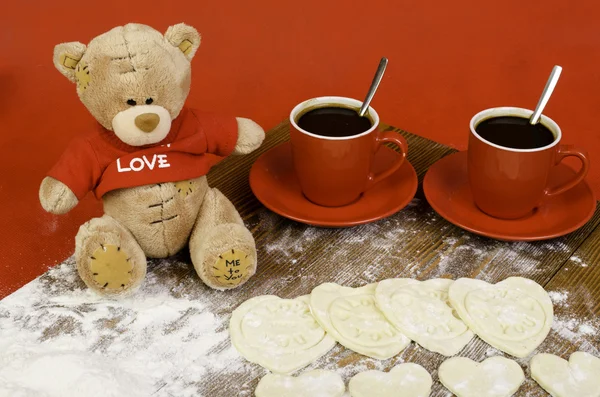 Hearts of dough, teddy bear and red cup of coffee. — Stock Photo, Image