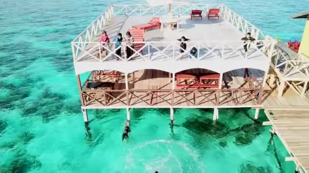センポルナ マレーシア 11月24 2019 空中ビュー幸せなアジアの子供たちはリゾートテラスから飛び降り 透明なターコイズグリーンの湾の水で泳ぐ — ストック動画