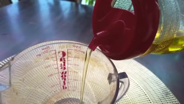 Pouring Vegetable Oil Measuring Glass Cup — Stock Video